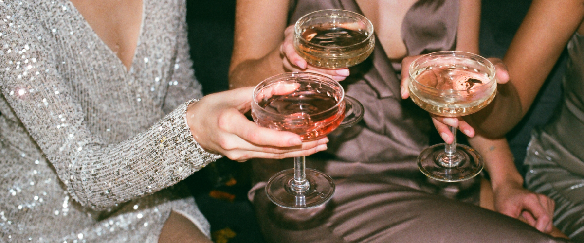 three women clinking champagne coups